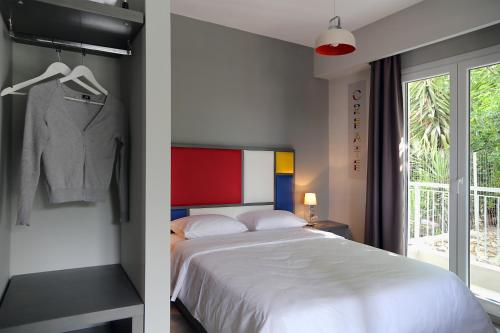 a bedroom with a bed next to a window at Design Architectonika in Skiathos Town