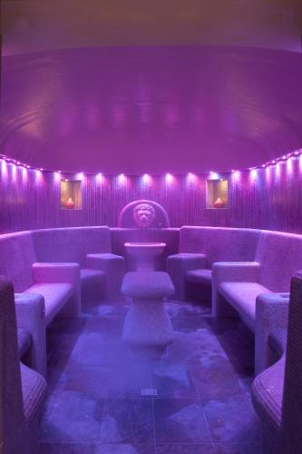 a purple room with chairs and a table and lights at Grand Hotel Trieste & Victoria in Abano Terme
