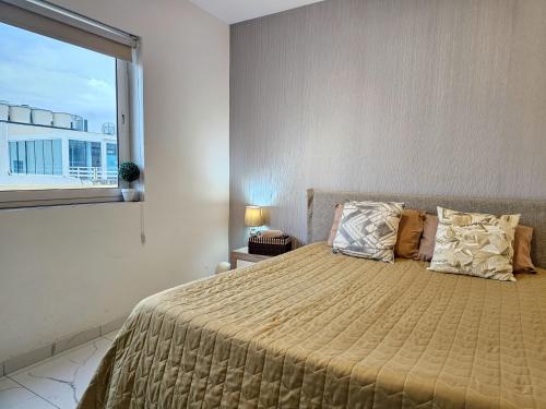 a bedroom with a large bed with a large window at MIVE Luxury Sea View Penthouse in Il-Gżira
