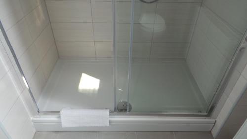 a bathroom with a shower with a glass shower stall at Hostel Levicki in Slavonski Brod
