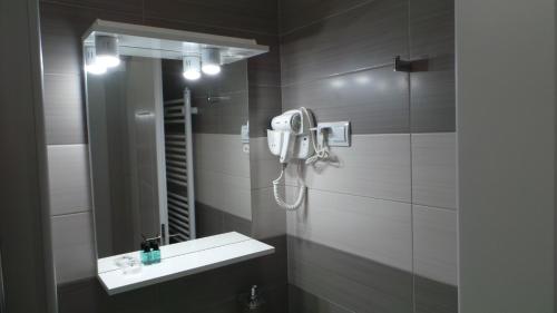 a bathroom with a sink and a mirror at Hostel Levicki in Slavonski Brod