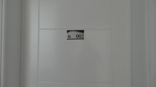 a white door with a sticker on it at Hostel Levicki in Slavonski Brod