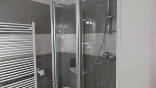 a bathroom with a shower with a glass door at Hostel Levicki in Slavonski Brod