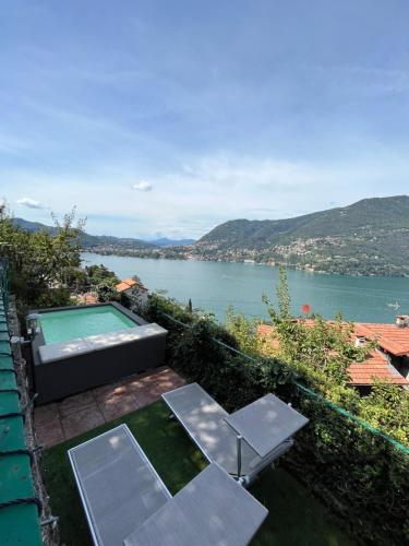 a house with a swimming pool and a view of the water at VILLA Como, Jacuzzi Spa and Private Pool in Blevio