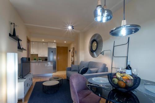 a living room with a couch and a table at La Quinta Esencia by Unique Rooms in Burgos