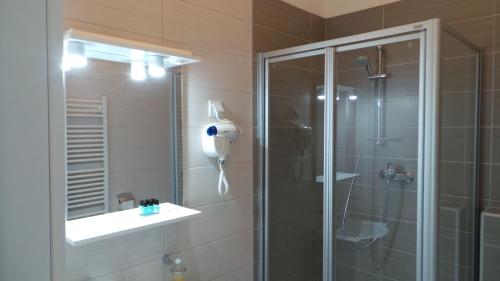 a bathroom with a shower and a glass shower stall at Hostel Levicki in Slavonski Brod