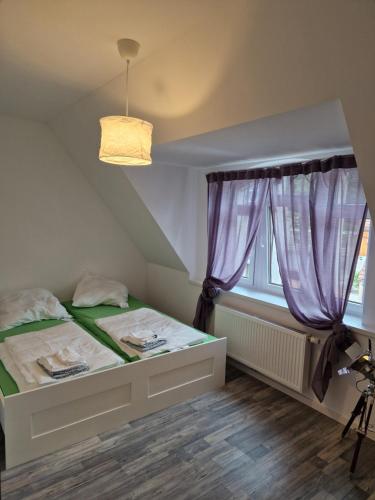 a small bedroom with a bed and a window at Ausblick Freital in Freital