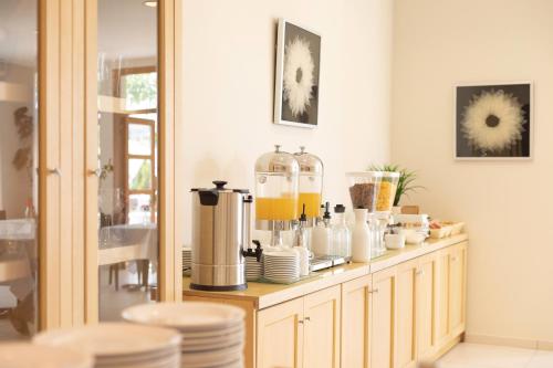 a counter with cups and plates on it at Skiathos Avaton Garden, Philian Hotels and Resorts in Skiathos Town