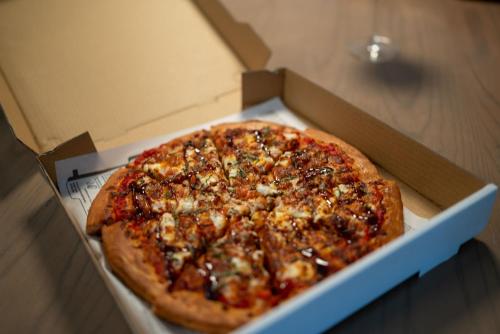 a pizza in a box on a table at Lake Louise Inn in Lake Louise