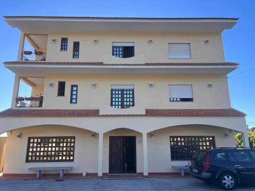 a building with a car parked in front of it at Pensão Repouso do Peregrino in Paredes de Coura