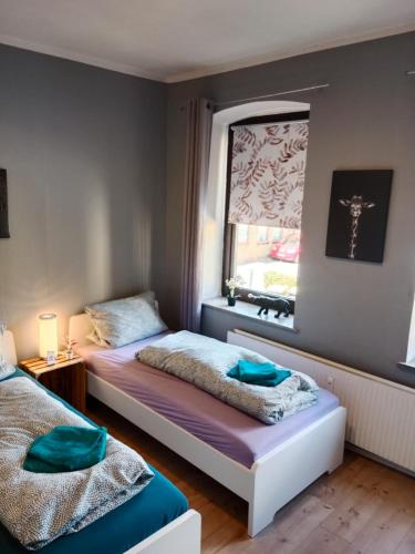 a bedroom with two beds and a window at Flensburg City 6 EG L in Flensburg