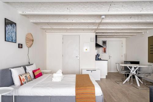 a bedroom with a large bed and a table at Smartflats - the City Antwerp in Antwerp