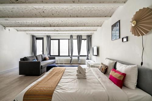 a bedroom with a large bed and a living room at Smartflats - the City Antwerp in Antwerp