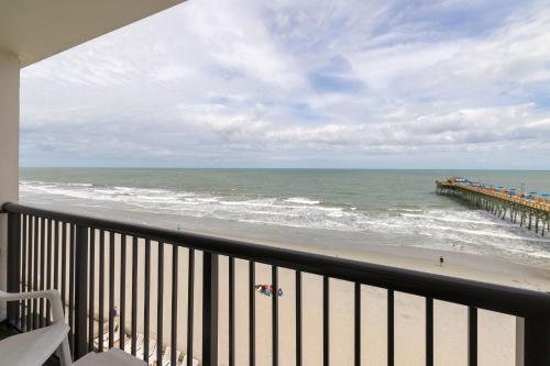 a balcony with a view of the ocean and a pier at Kingfisher Inn in Myrtle Beach