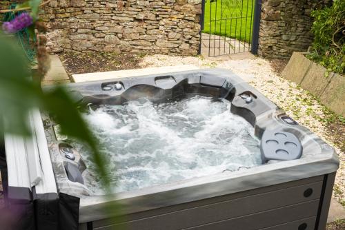 a hot tub with water in it in a garden at Timber Hill - Parkfields in Haverfordwest