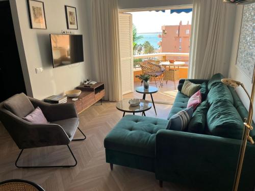 a living room with a green couch and chairs at Mirador de Sanlucar 9 in Sanlúcar de Barrameda