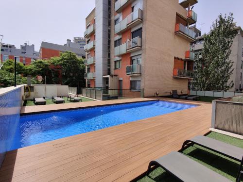 a swimming pool on the roof of a building at Family apartment Forum in Barcelona