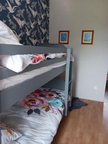 a bunk bed in a room with a bunk bedsheet at Cherry Blossom House in Bujaleuf