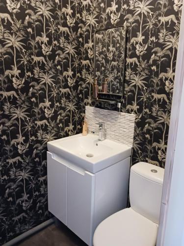a bathroom with a white sink and a toilet at Cherry Blossom House in Bujaleuf