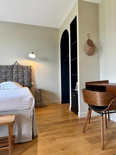 a bedroom with a bed and a desk and a piano at Le Château de Saint-Angel, Le Manoir du Rigouneix, 5 minutes A89, nature, calme, sauna in Saint-Angel