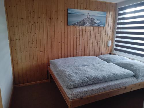 a bedroom with a bed with a picture on the wall at FEWO Isla 1 in Elmenhorst