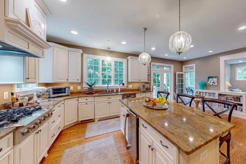a kitchen with white cabinets and a bowl of fruit on the counter at Ensign's Ridge in Annapolis
