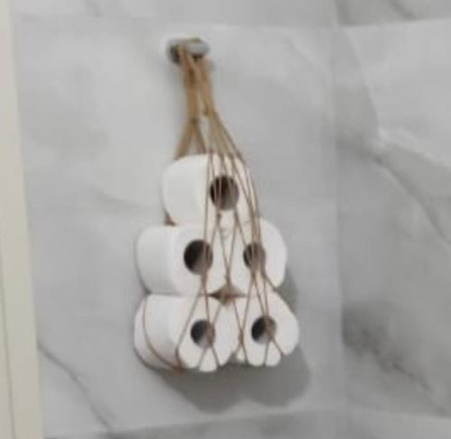 a bunch of toilet paper in a holder on a wall at Villa Dyrrahu in Golem