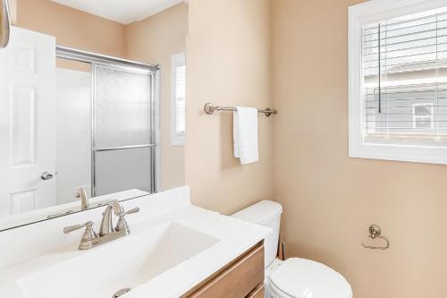 a bathroom with a sink and a toilet at Vanodi Landing in North Topsail Beach