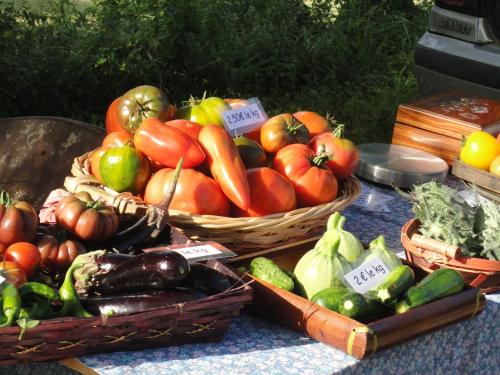 a bunch of vegetables in baskets on a table at Château d’Orion in Orion