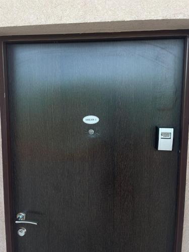 a black door with a sign on it at Dream 1 in Belgrade