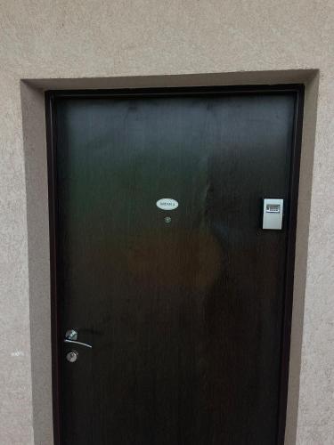 a black door with a sign in front of it at Dream 1 in Belgrade