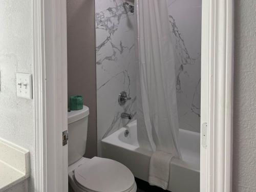 a white bathroom with a toilet and a shower at Motel 6-Lafayette, IN in Lafayette
