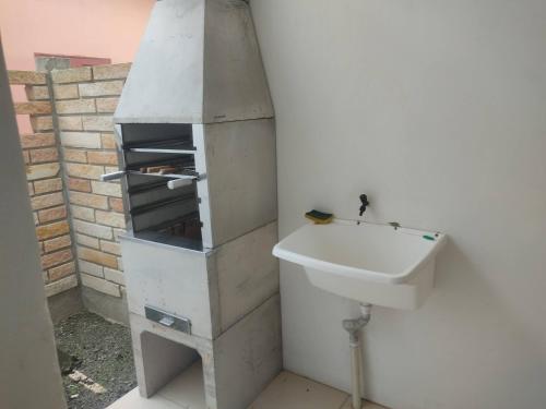 a bathroom with a sink and a white sink at Residencial Ramos in Torres