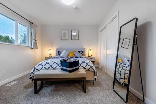 a bedroom with a bed and a mirror at Convenient Quiet Home for Family Business Trip in Newcastle