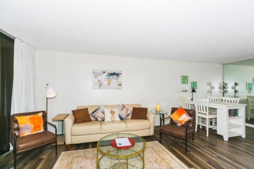 a living room with a couch and two chairs at Discovery Bay 3513 in Honolulu