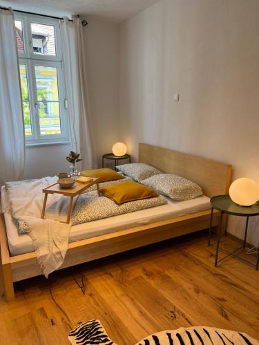 a bedroom with a bed with a table on it at Wohnung in Graz in Graz