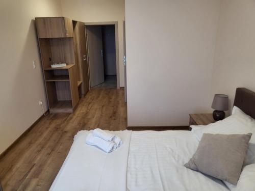 a bedroom with a bed with a towel on it at Restauracja & Pokoje Gościnne Polowczyk in Miąskowo