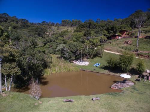 an aerial view of a pond in a field at Quinta dos Pinhais Pouso e Charme in Santo Antônio do Pinhal