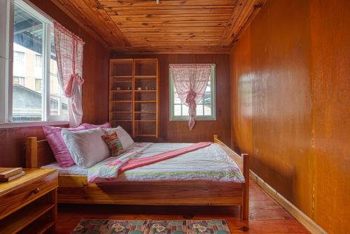 a bedroom with a bed and a window at Gina’s Homes in Sagada