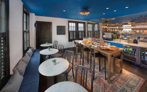 a restaurant with tables and chairs and a bar at The Poppy Georgetown Guesthouse and Gardens in Washington