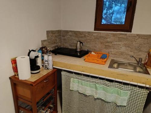 a kitchen with a sink and a counter top at L'atmosfera in Brindisi