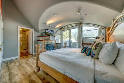 a bedroom with a large white bed in a room at The Royal Suite - Village Penthouse, Private Hot Tub with Mountain Views in Whistler