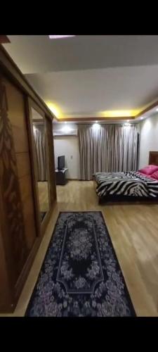 a bedroom with a bed and a rug on the floor at VIP Apartment حامعه الدول العربيه Mohandsein in Cairo