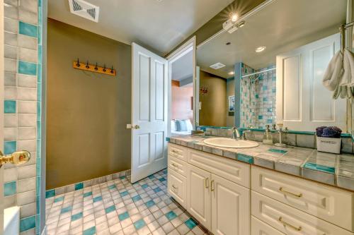 a bathroom with a sink and a mirror at The Royal Suite - Village Penthouse, Private Hot Tub with Mountain Views in Whistler