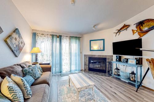 a living room with a couch and a fireplace at Sunset Dunes in Ocean Shores