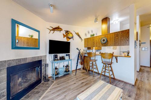 a living room with a fireplace and a tv at Sunset Dunes in Ocean Shores