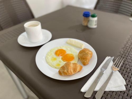 a plate of eggs and croissants on a table at Ayenda Marana in Manizales