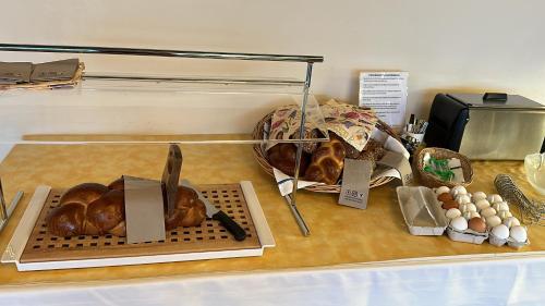 a display case with bread and eggs on a table at B&B Hotel Mattli Übernachtung Frühstück in Morschach