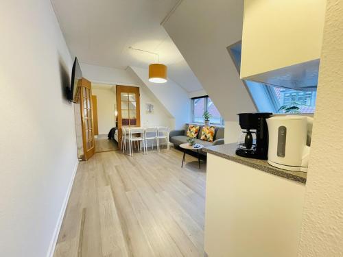a kitchen and living room with a couch and a table at aday - Great 1 bedroom central apartment in Hjørring
