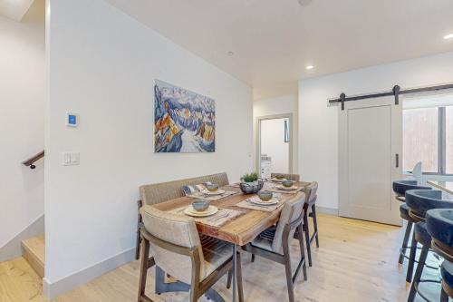 a dining room with a wooden table and chairs at Alpine Vista Haven in Silverthorne